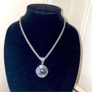 Large hematite pendant necklace on a thick silver chain.